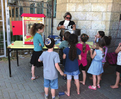 children at a popcorn stand